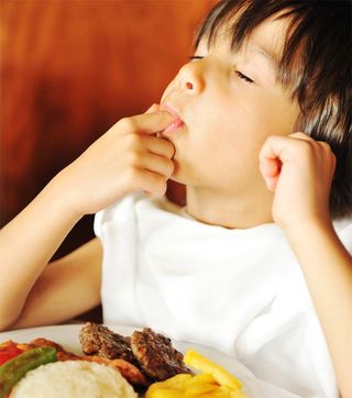 Cute boy really enjoying his food.