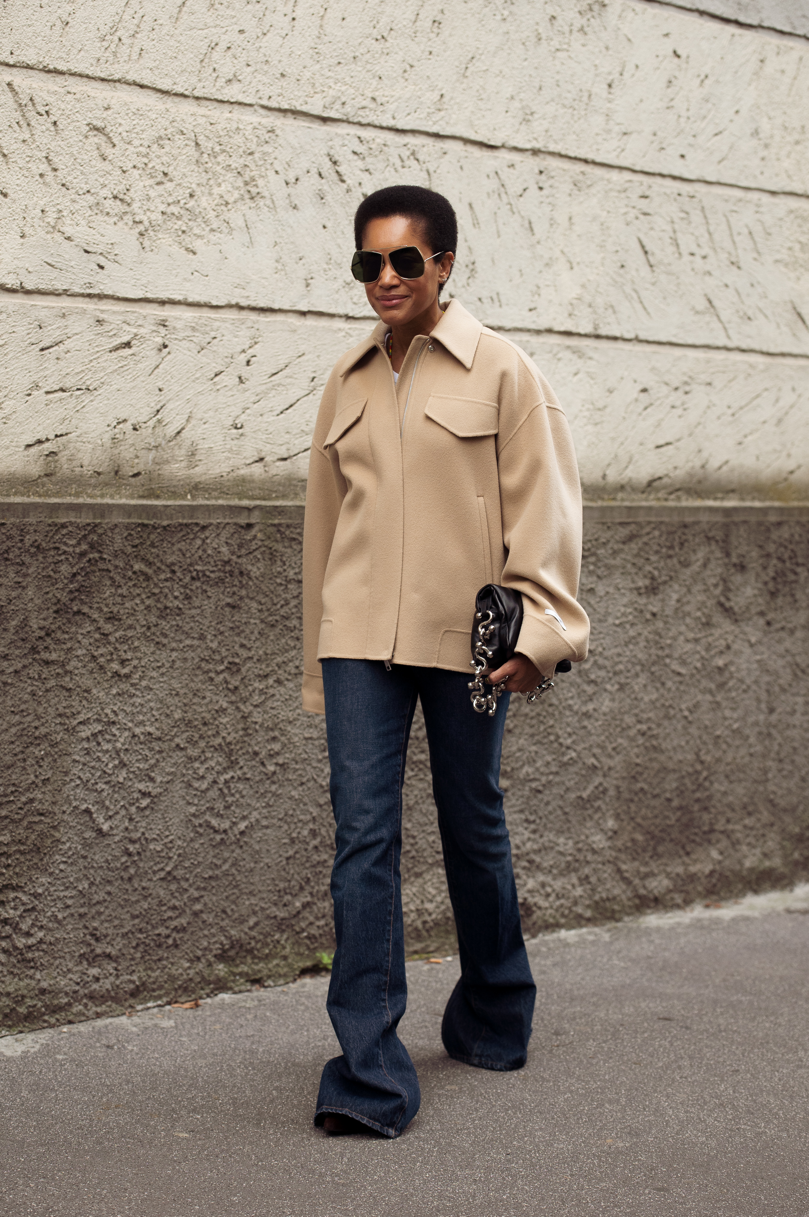 MILAN, ITALY - SEPTEMBER 26: Tamu McPherson wears a beige oversized jacket with flared jeans and aviator sunglasses outside Sportmax show during the Milan Fashion Week Menswear Spring/Summer 2026 on September 26, 2025 in Milan, Italy. (Photo by Raimonda Kulikauskiene/Getty Images)