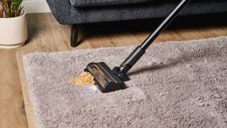 A black and gold Dreame R10 Pro cordless vacuum cleaner