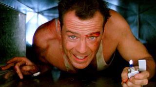 A still from the movie Die Hard in which Bruce Willis plays John McClane as he crawls through a vent.