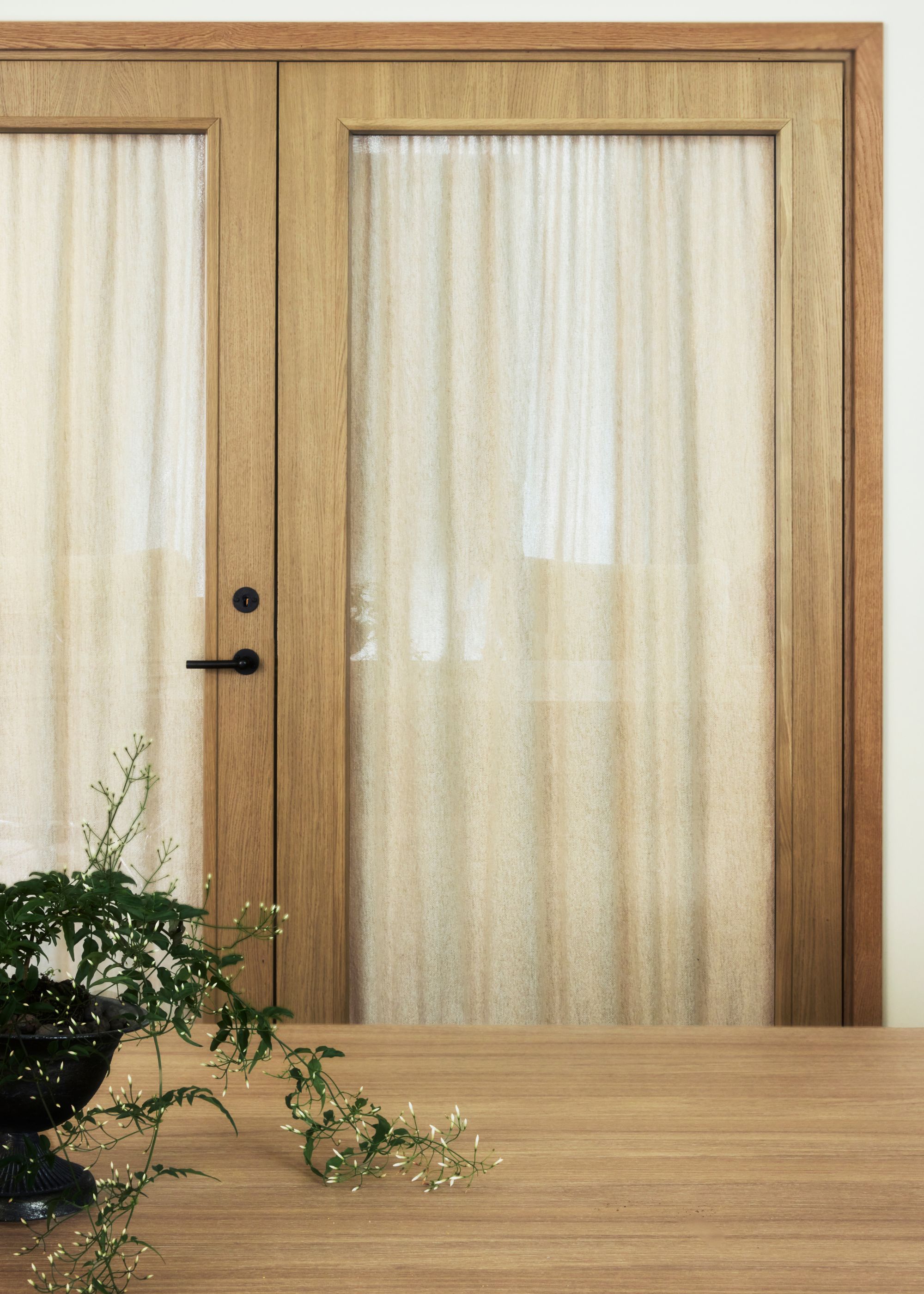Internal wooden French doors with cafe curtains.
