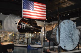 The Gemini 6 spacecraft is positioned for display opposite a full-scale mockup of a Gemini spacecraft at the Stafford Air & Space Museum in Weatherford, Oklahoma.