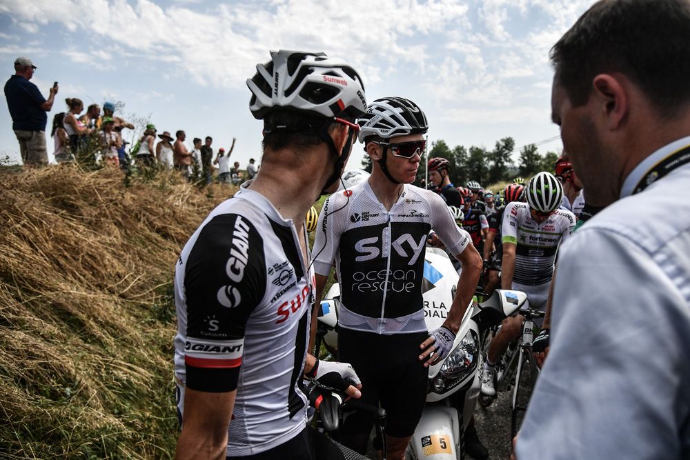 Chris Froome (Team Sky) and other riders wait for the stage to start after the protest