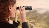 Image shows a woman using one of the best monocular devices