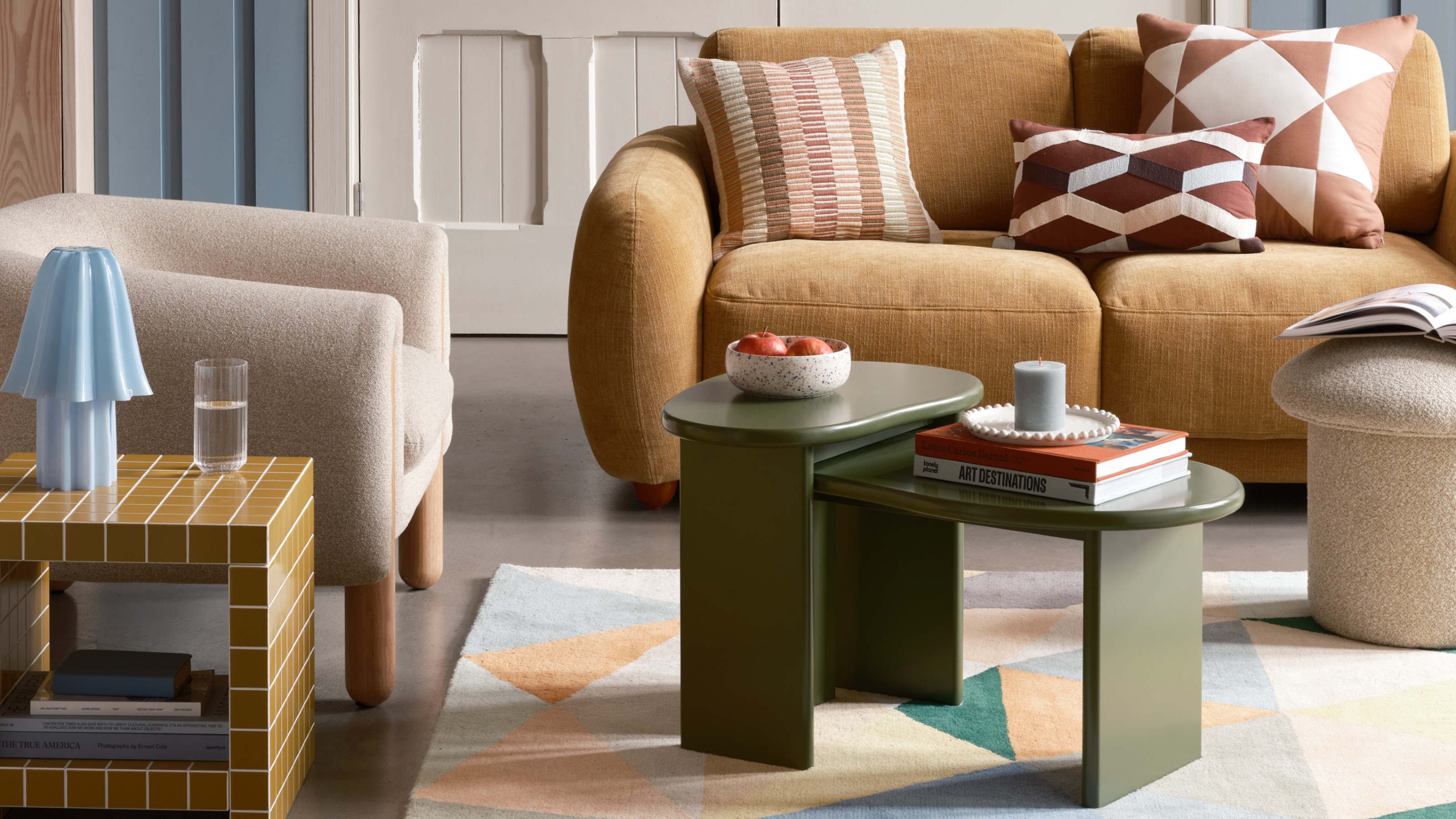 A living room with Habitat's Drape boucle armchair and a tiled side table next to it