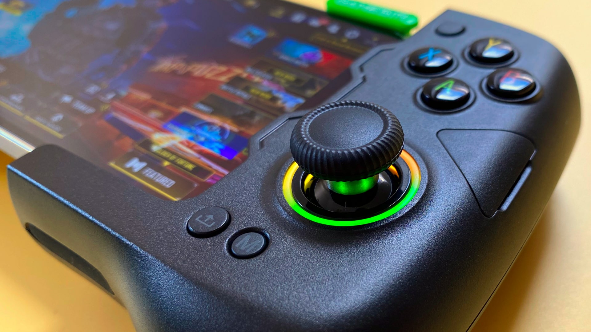 The GameSir X4 Aileron iOS games controller against a yellow background.