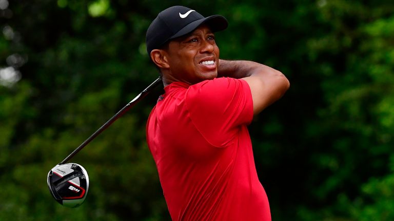 Tiger Woods plays a tee shot at the 2019 Masters