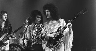 Queen live in 1974: Freddie Mercury and Brian May stand shoulder to shoulder on stage, while (left) John Deacon holds down the bass.