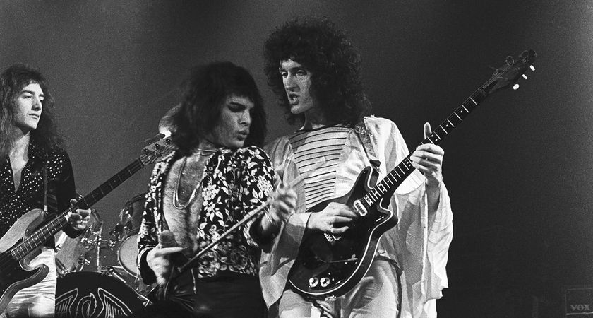 Queen live in 1974: Freddie Mercury and Brian May stand shoulder to shoulder on stage, while (left) John Deacon holds down the bass.