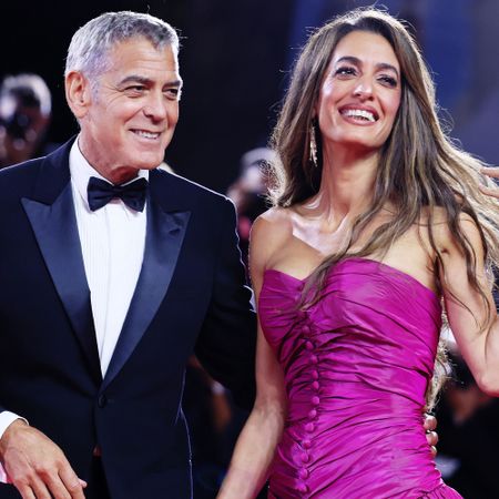 Amal Clooney wears the controversial high-low dress trend on the red carpet in a purple gown
