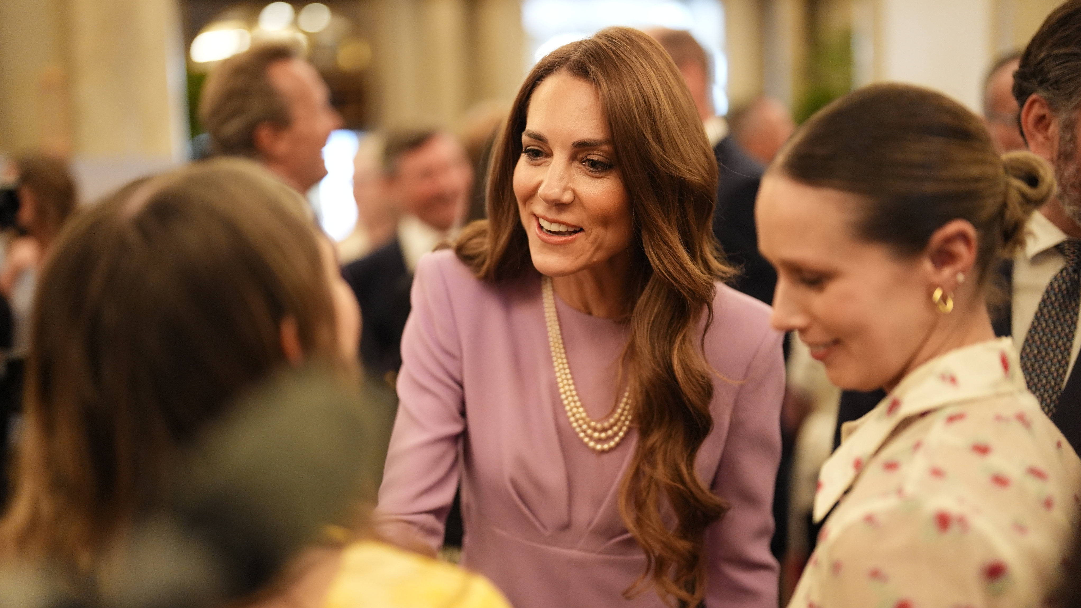Catherine, Princess of Wales speaks with guests as she attends a reception at Buckingham Palace, on the 100th anniversary of the birth of Queen Elizabeth II on April 21, 2026