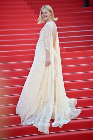 Elle Fanning at the 2024 Cannes Film Festival wearing a long backless dress by Gucci