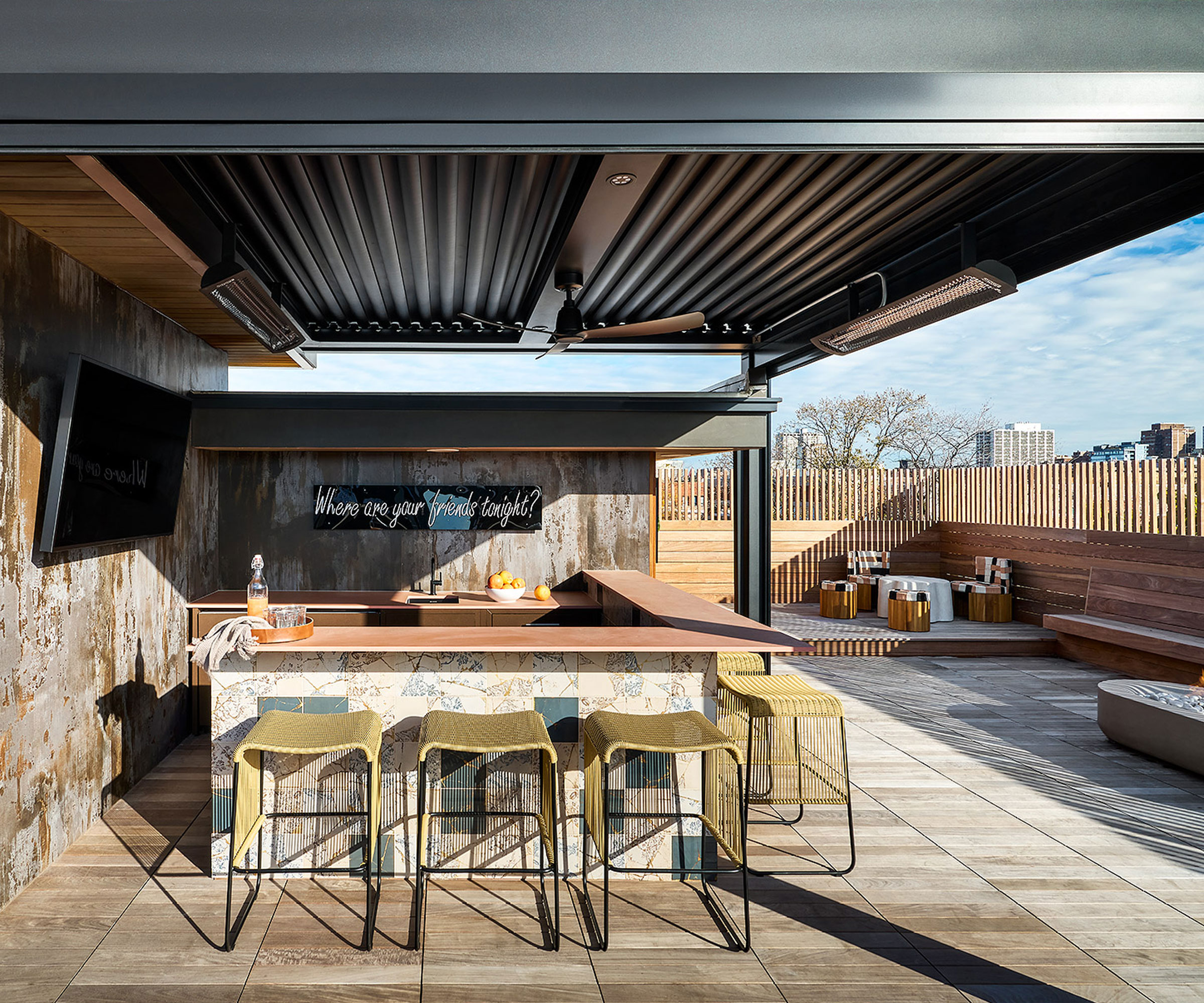 rooftop patio bar with bar stools and outdoor TV, ceiling fan and integrated heat lamps