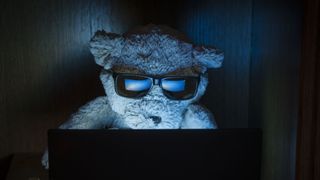 Fancy Bear Hacker sitting in front of laptop