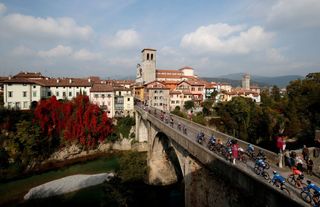 Cyclists ride over the Ponte del Diavolo Diable bridge in Cividale del Friuli during the 16th stage of the Giro dItalia 2020 cycling race a 229 km between Udine and San Daniele in Udine on October 20 2020 Photo by Luca Bettini AFP Photo by LUCA BETTINIAFP via Getty Images