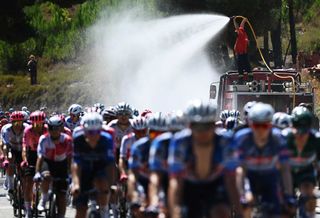 CASTELO BRANCO PORTUGAL AUGUST 19 The fire service refreshes the peloton during during the La Vuelta 79th Tour of Spain 2024 Stage 3 a 1915km stage from Lousa to Castelo Branco UCIWT on August 19 2024 in Castelo Branco Portugal Photo by Dario BelingheriGetty Images