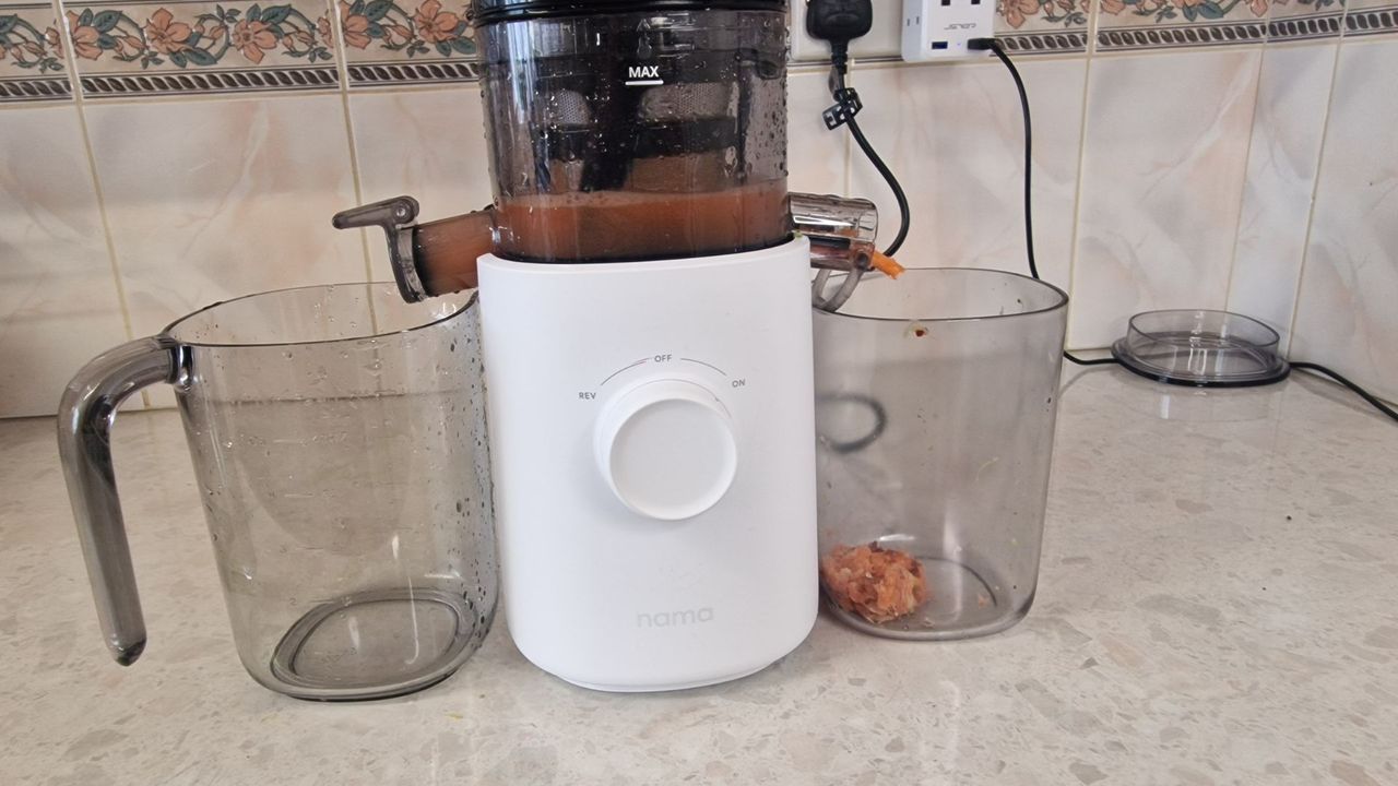 The waste from the Nama J3 juicer next to the white base of the mahcine