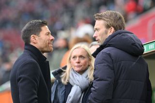 Head coach Xabi Alonso and sporting director Simon Rolfes of Bayer 04 Leverkusen talk prior to the Bundesliga match between FC Augsburg and Bayer 04 Leverkusen at WWK-Arena on January 13, 2024 in Augsburg, Germany.