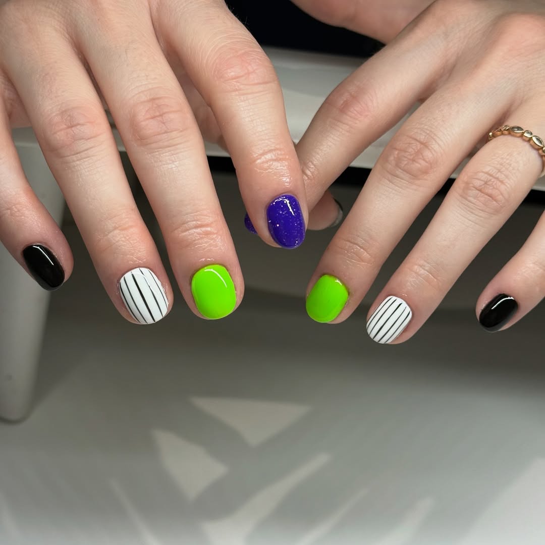 beetlejuice manicure with green and black nails
