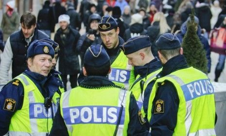 Swedish police patrol the Drottninggatan shopping street in Central Stockholm, near the site where an Iraqi-born Swedish citizen lost his life in an alleged suicide bomb incident.