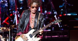 Joe Perry of Aerosmith plays live with a beat-up old Mosrite-esque Danelectro with a white finish.