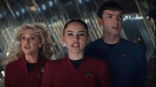 Two women and one man sing in red and blue Star Trek uniforms