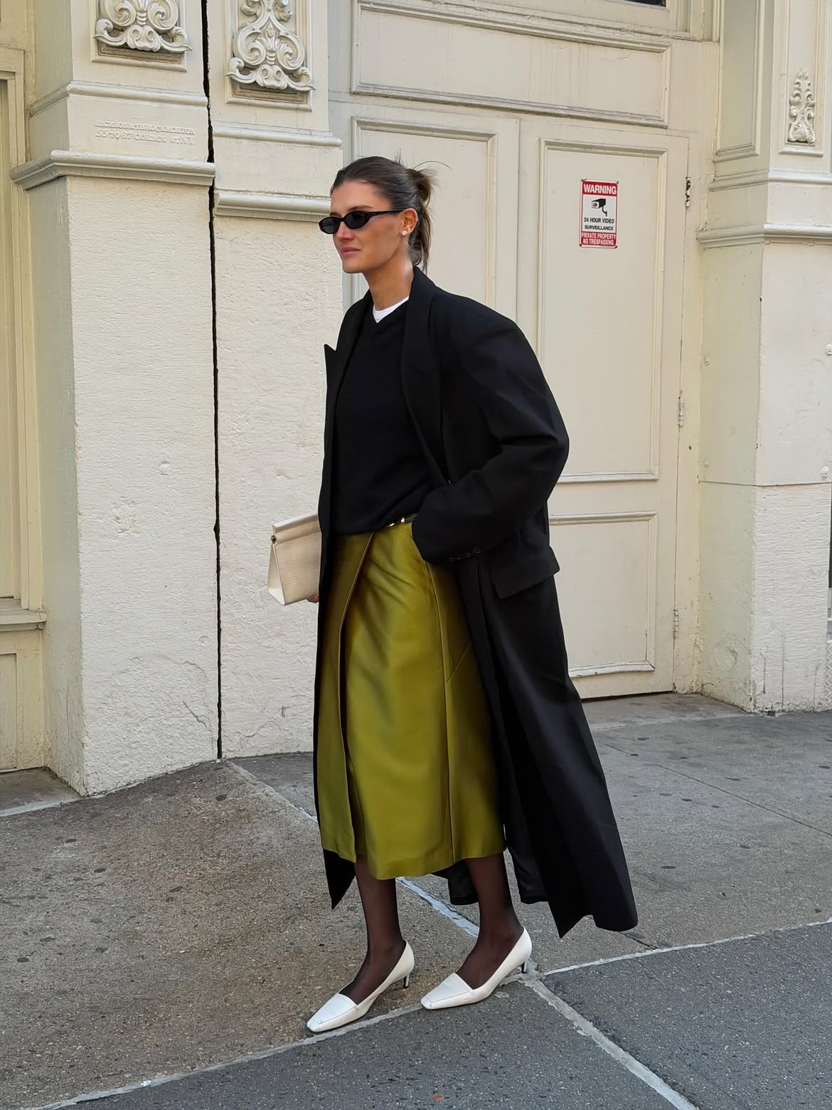 Chartreuse skirt and black coat.