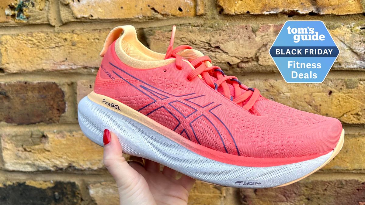 Person holding the Asics Gel Nimbus 25 pink running shoe