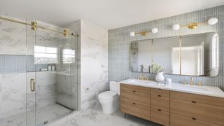 A neat and well organised bathroom with a double vanity showing loads of storage and a large walk-in shower 