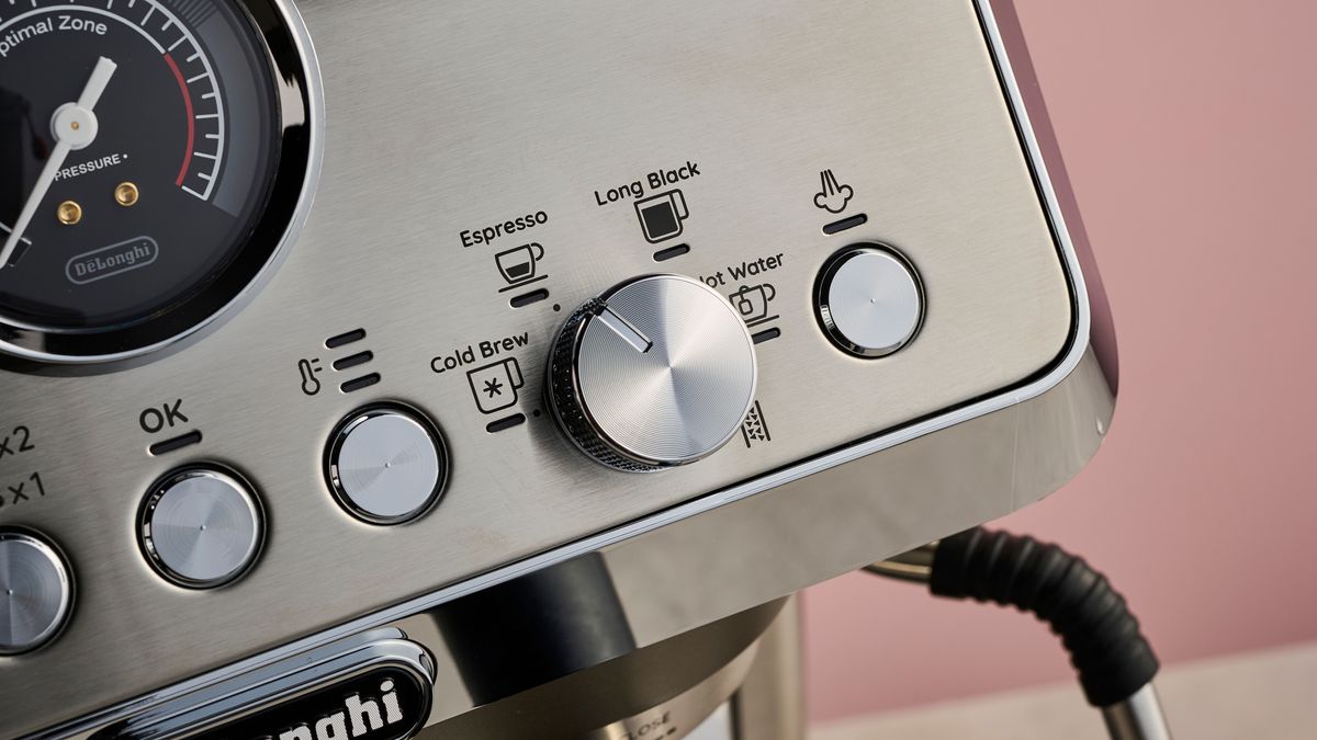 A close-up view of the okay, temperature, and steam arm buttons, along with the dial to select drink types.
