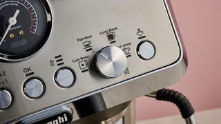 A close-up view of the OK, temperature, and steam arm buttons, along with the dial to select drink types.