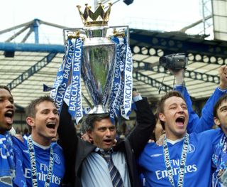 Chelsea manager Jose Mourinho celebrates with the Premier League trophy on his head, flanked by players Frank Lampard and captain John Terry, after winning the 2004/05 title