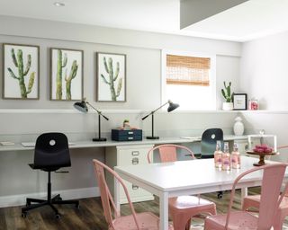 Basement homework area with white desks and cabinets, white table and pink chairs