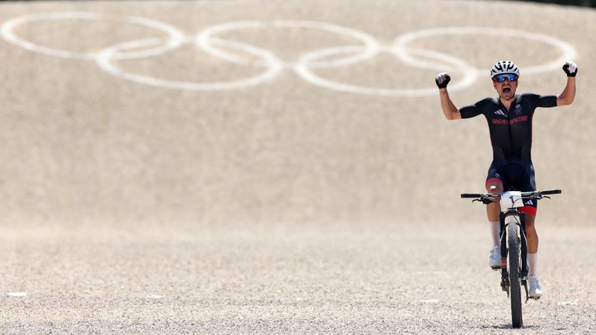 Tom Pidcock crossing the line and winning gold at the 2024 Paris Olympic