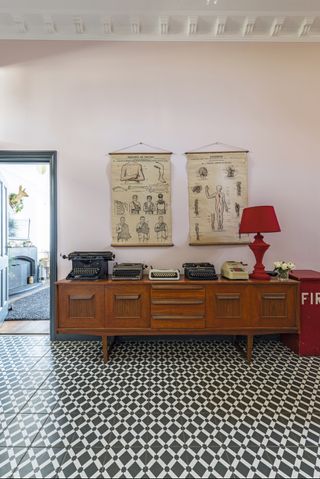 Hallway with monochrome tiles and antique sideboard