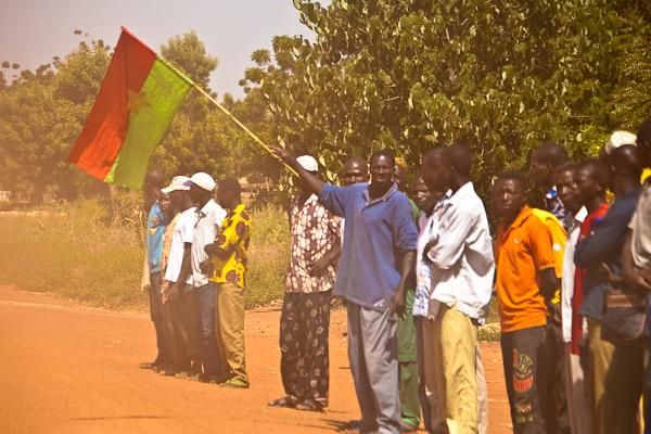 Spectators wave a Burkina Faso flag.