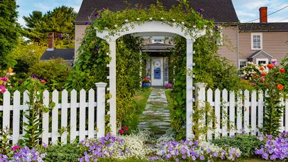 white fence and gate with garden arch
