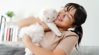 Woman hugging cat