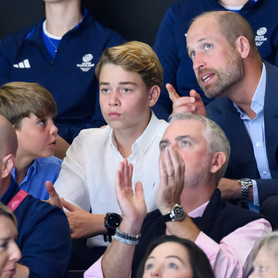 Prince William sitting in the stands at the Commonwealth Games talking to Prince Louis and Prince George