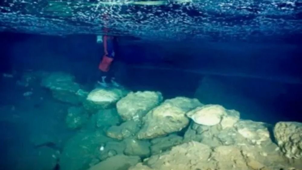 An underwater image of a stone bridge