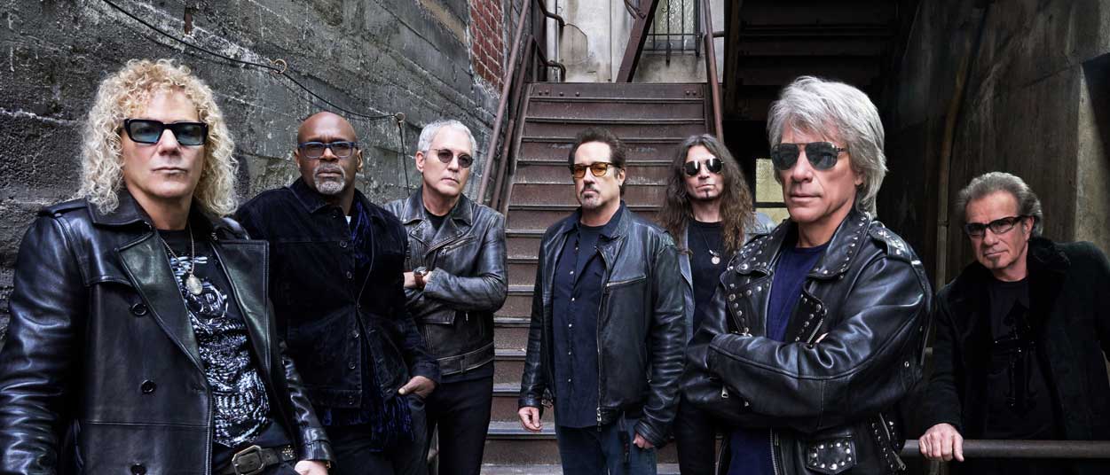 Bon Jovi posing in an alleyway