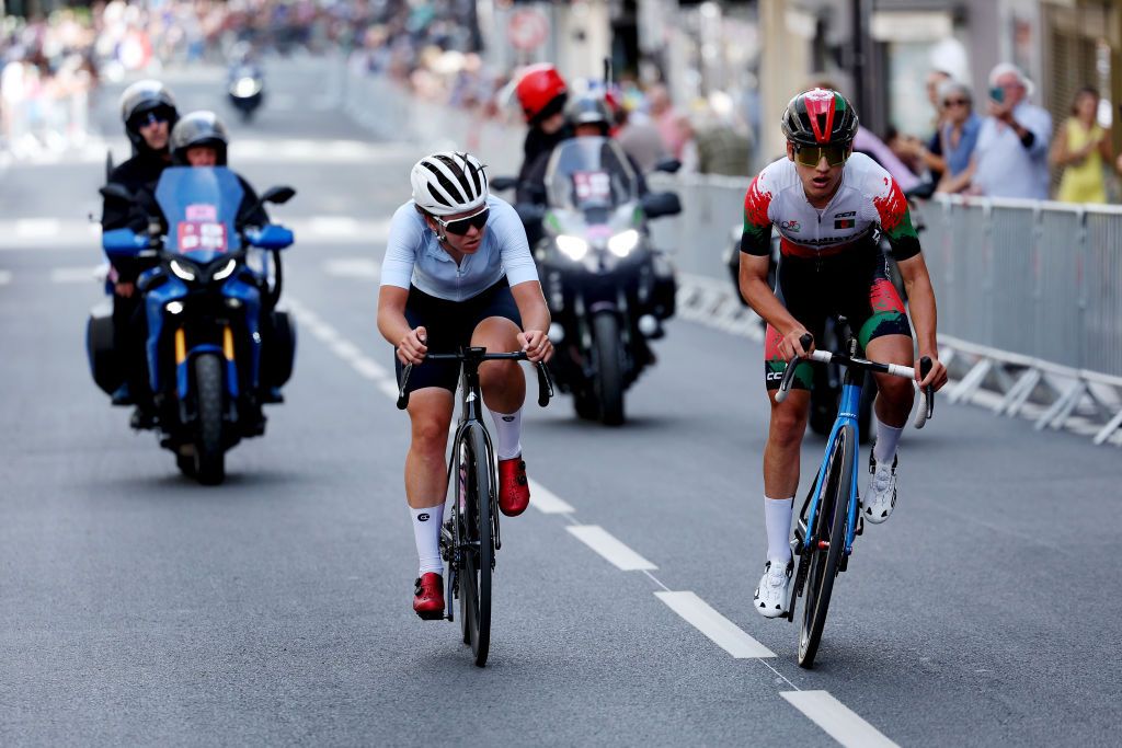 PARIS FRANCE AUGUST 04 LR Hanna Tserakh of Team Individual Neutral Athletes and Fariba Hashimi of Team Afghanistan compete in the breakaway during the Womens Road Race on day nine of the Olympic Games Paris 2024 at Trocadero on August 04 2024 in Paris France Photo by Alex BroadwayGetty Images