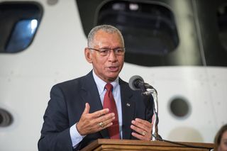 NASA Administrator Charlie Bolden, standing in front of an Orion mockup, speaks at an event at NASA's Johnson Space Center on Aug. 20, 2013.