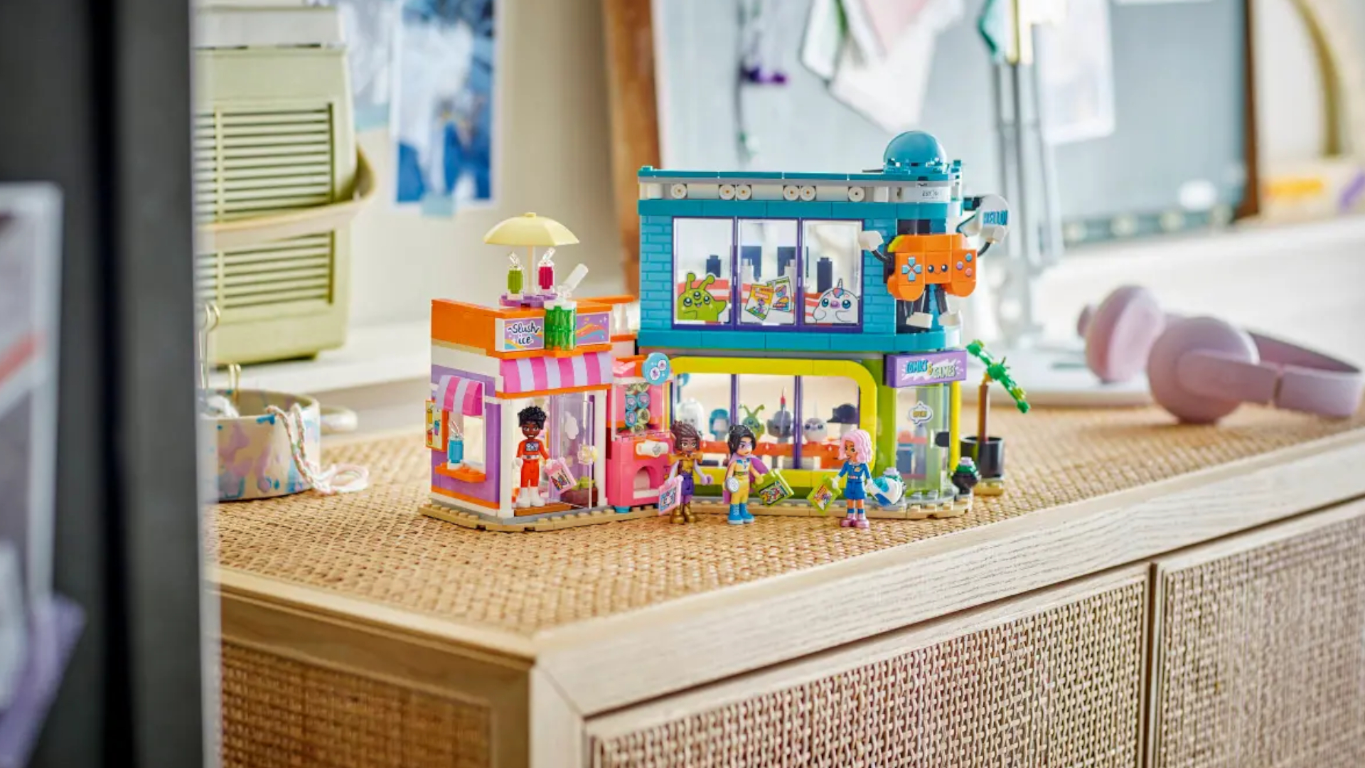 The Lego Comic Book and Game Store with minifigures on a wicker cabinet, with a radio and headphones visible in the background