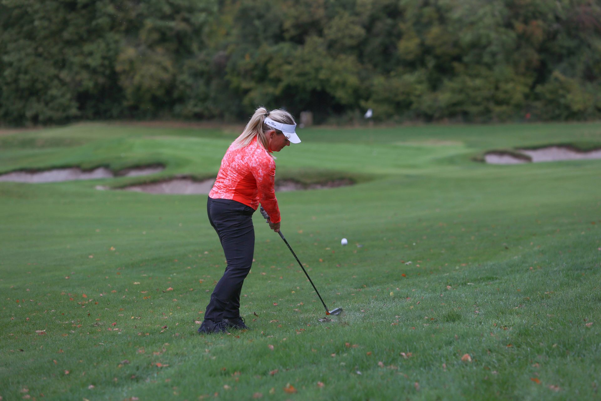 Carly Frost plays a chip shot