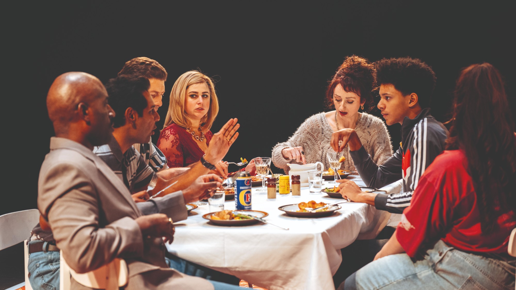 Family gathered round the table in Ilford Boy