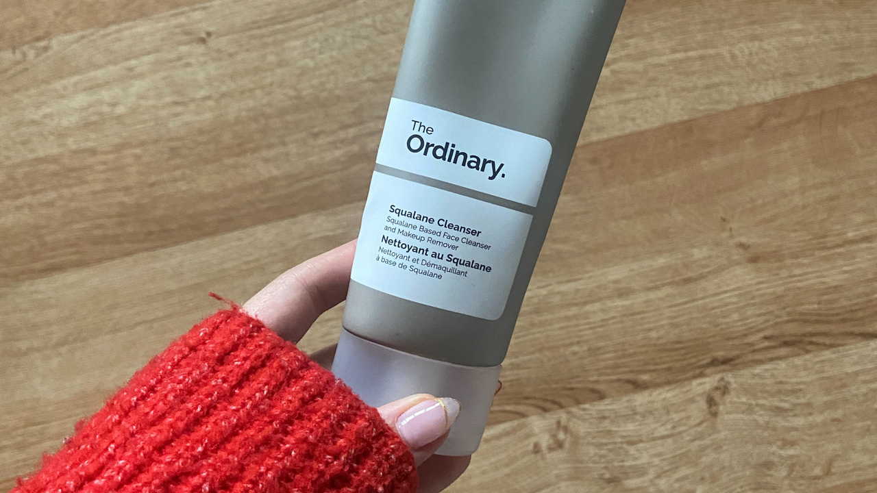 Rebecca Fearn holding a bottle of The Ordinary Squalane Cleanser