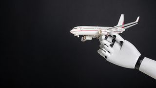 Robotic hand holding airplane model. Integration of robotics and automation in aviation, modernization of flight control technologies
