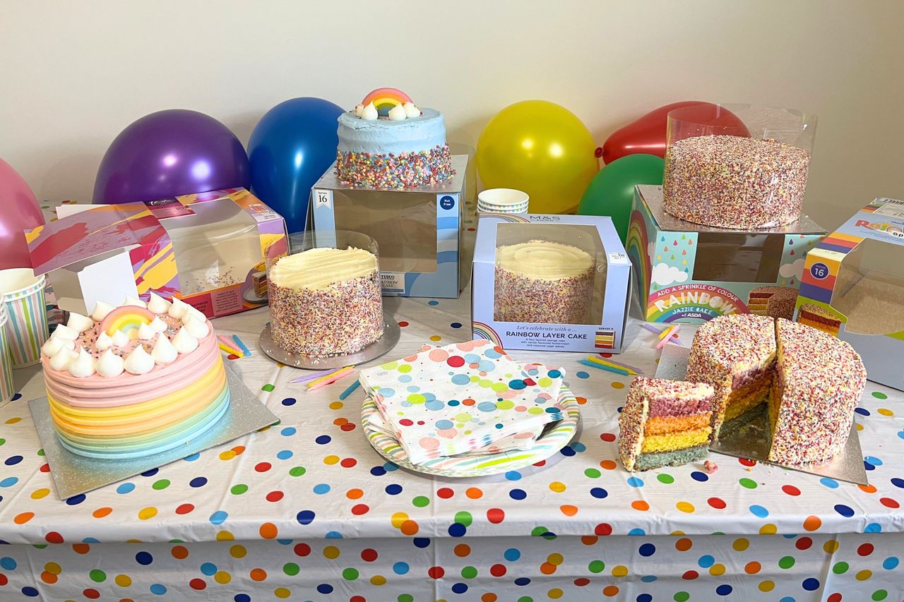 Table full of the best supermarket rainbow cakes tried and tested by GoodtoKnow&#039;s food editor