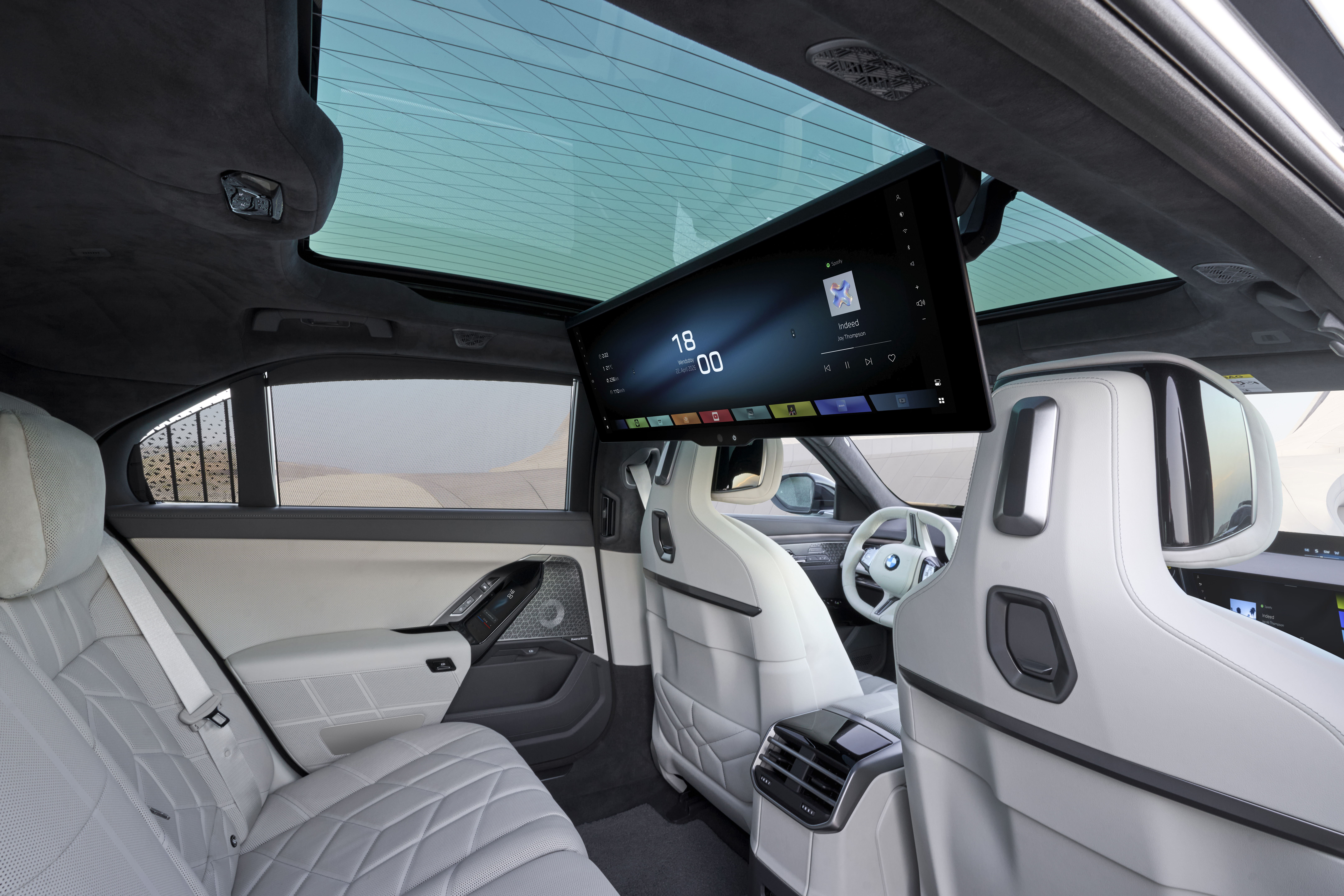 Interior picture of the BMW 7 Series showing a 31-inch TV screen folded down in the rear of the car